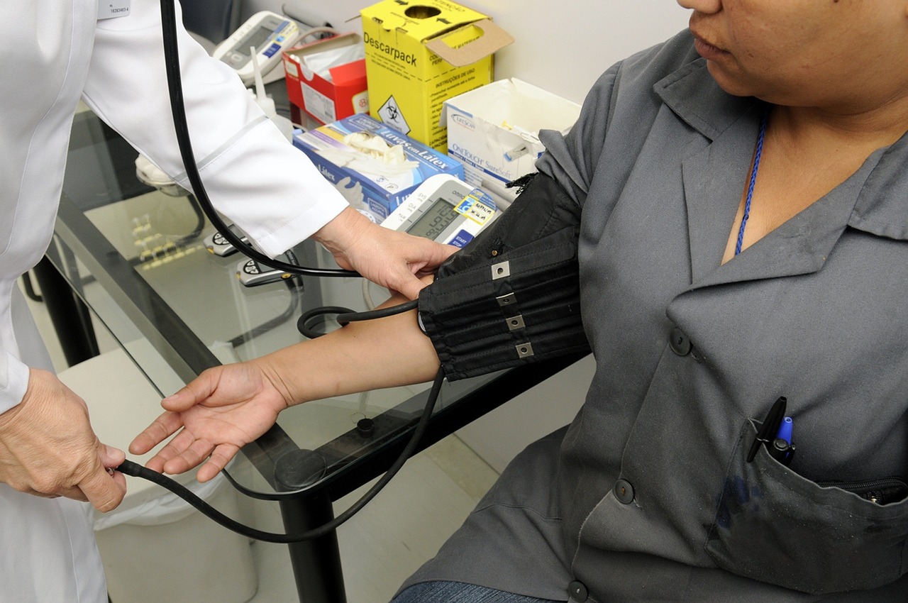 Clinician performing a wellness check in a chiropractic treatment room