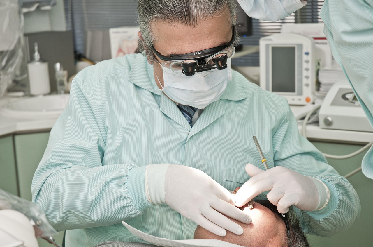 Dental team working chairside with patient care equipment