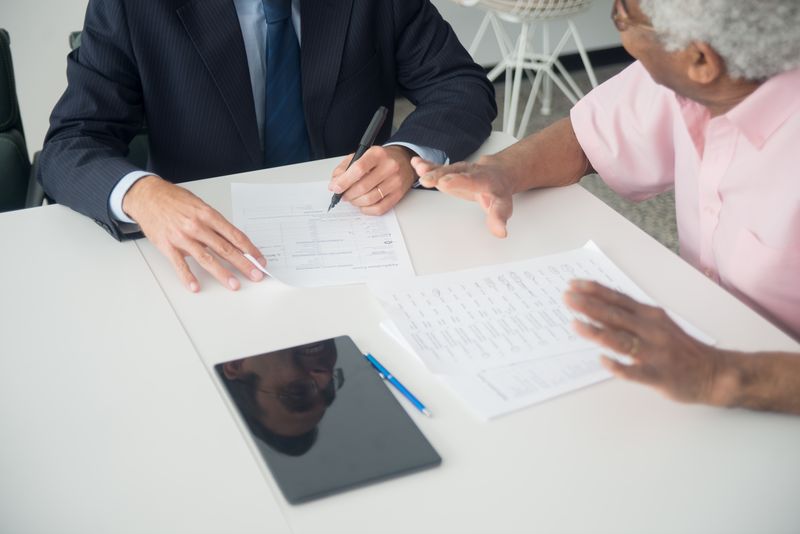 Financial advisor reviewing recommendations and paperwork with a client