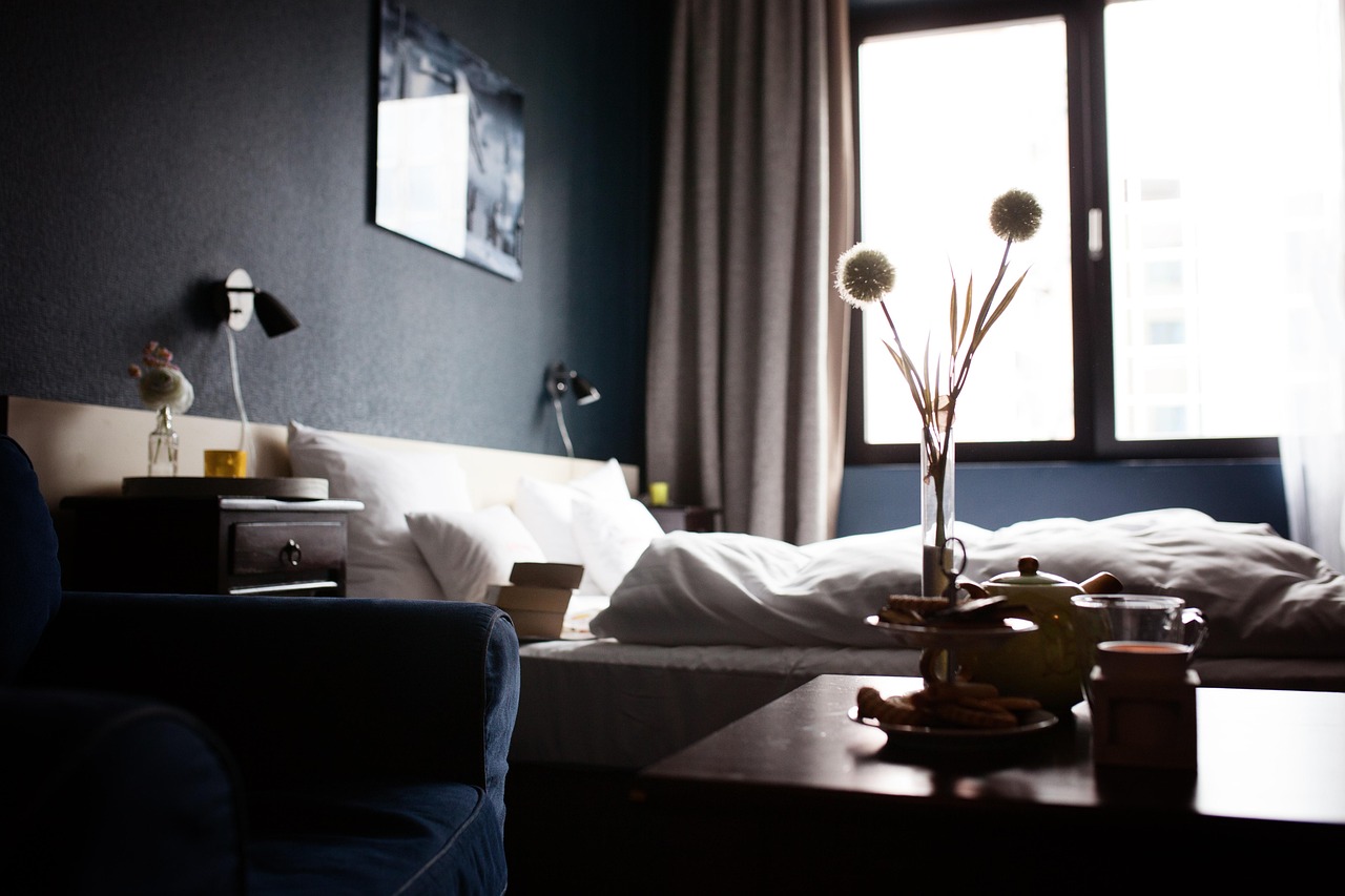 Hotel housekeeping employee preparing a guest room