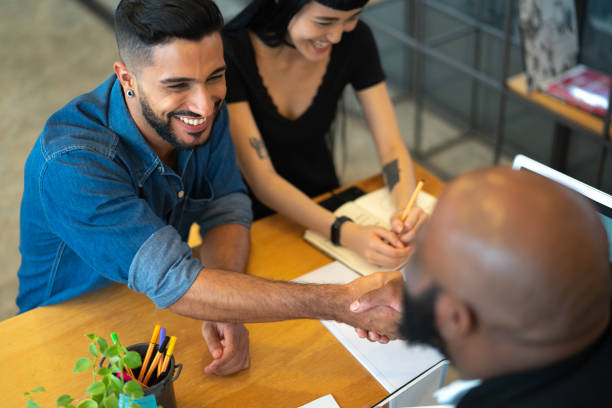Insurance agency team greeting and meeting with a client in an office