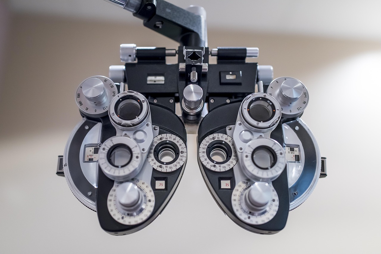 Optometrist performing an eye exam for a patient