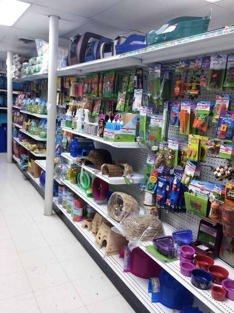 Pet supply aisle stocked with pet food and accessories in a pet store