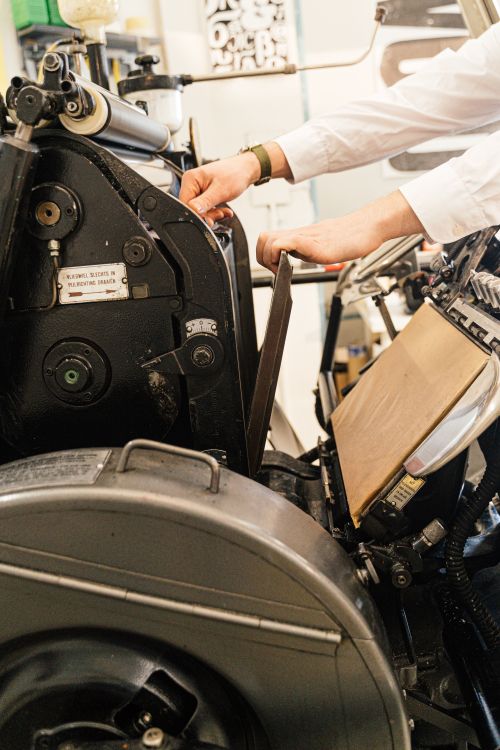 Close-up of printing press rollers and industrial finishing equipment