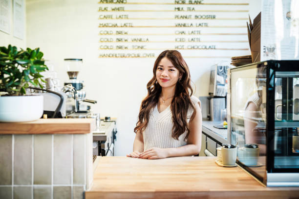 Coffee shop counter with barista serving customers