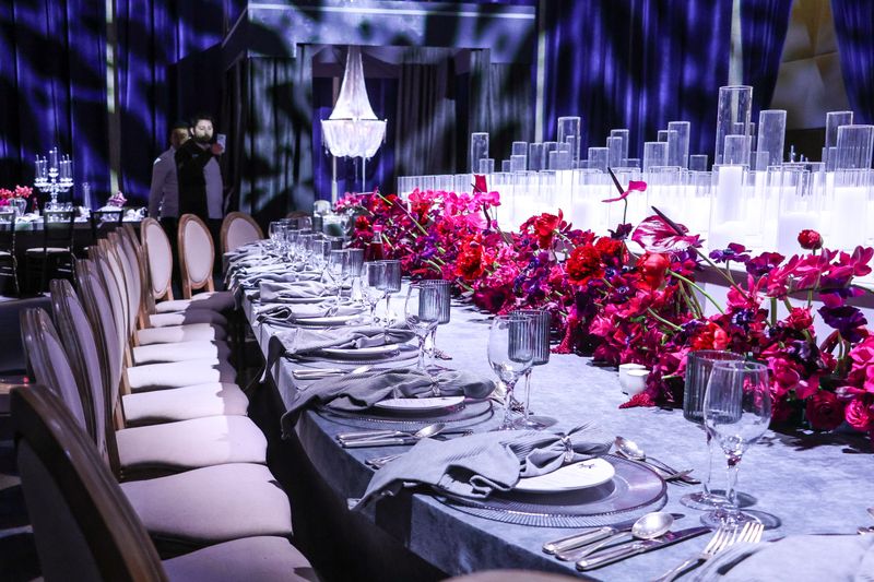 Elegant event table setting with floral decor arranged by an event planner