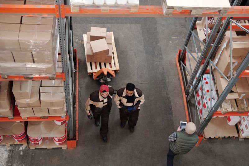 Warehouse workers organizing and preparing food and beverage shipments