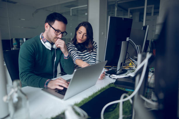 Software developers working at a technology company office