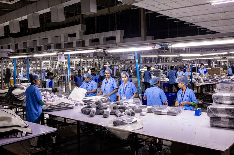 Factory workers on a light manufacturing assembly line